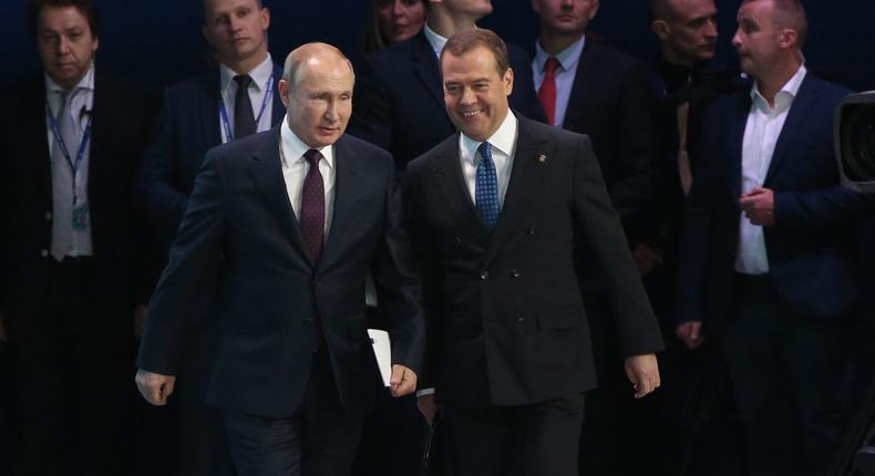 Russian President Vladimir Putin and then-Prime Minister Dmitry Medvedev enter the hall during the XIX Congress of United Russia Party on November 23, 2019 in Moscow, Russia.