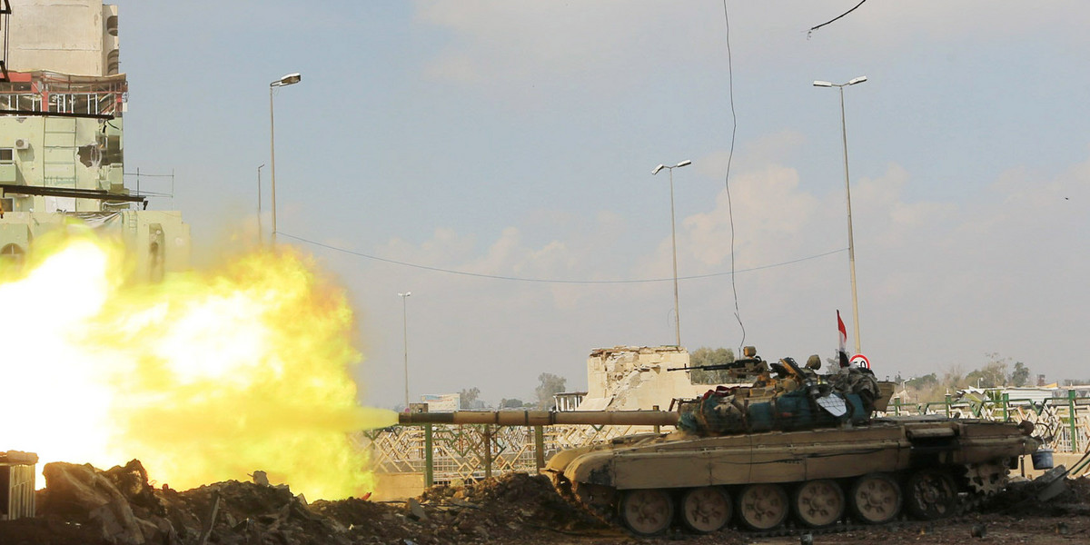 A Iraqi rapid-response forces tank fires against ISIS militants in the Bab al-Tob area of Mosul, Iraq, March 14, 2017.