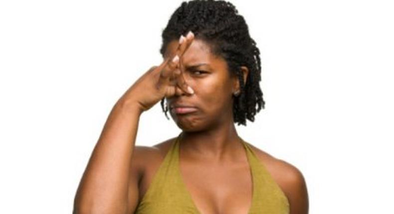 African woman covering her nose.