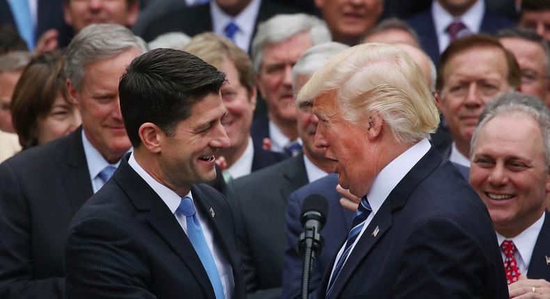House Speaker Paul Ryan and President Donald Trump shake hands at a celebration at the White House on Thursday.