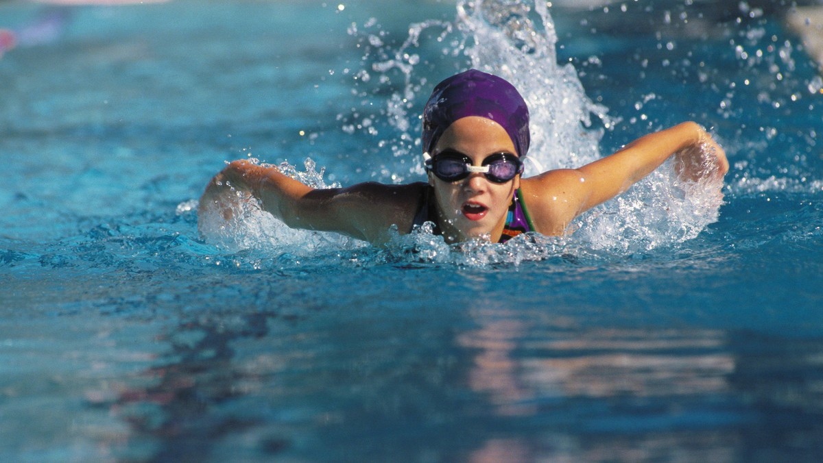 A young girl swimming in a pool