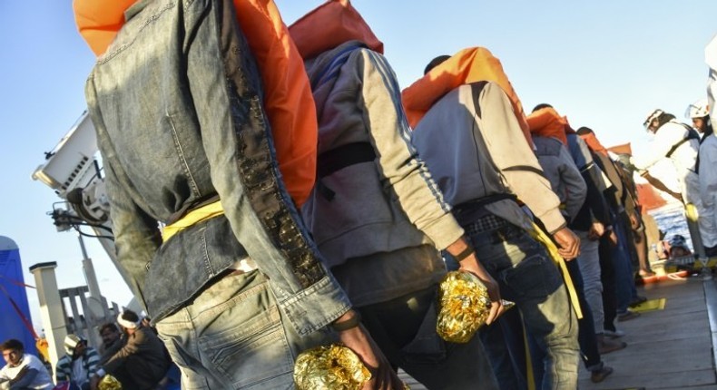 Rescued migrants and refugees wait to be transferred in 2016