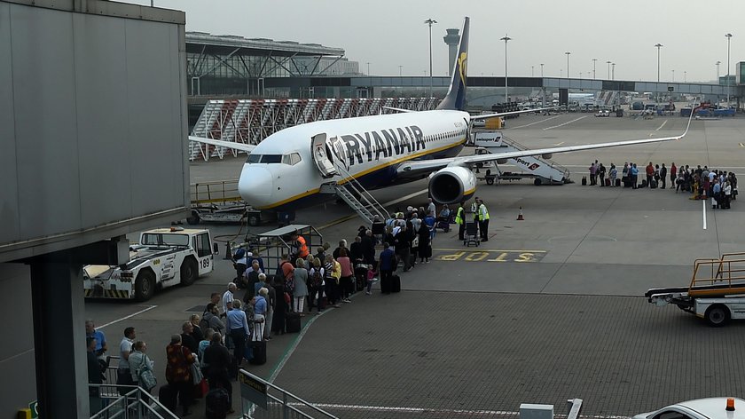 A cabin crew member serves passengers onboard a Ryanair passenger aircraft travelling from Madrid In