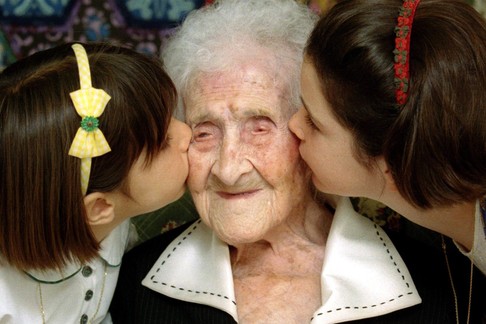 The World's oldest woman, Jeanne Calment, 120 years old, is kissed by two young girls during a speci