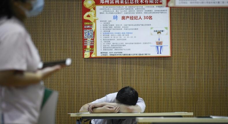 A jobseeker takes a break at a recruitment fair in Zhengzhou, China. Young graduates face a tough employment market