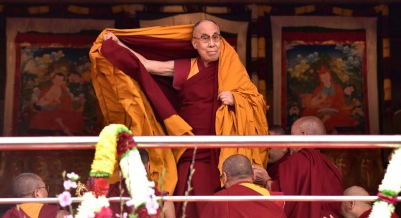 Exiled Tibetan spiritual leader the Dalai Lama adjusts his shawl as he arrives to deliver teachings to Buddhist followers at the Yiga Choezin ground in Tawang near the India-China border