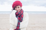 Cute smiling young woman in stylish warm clothing