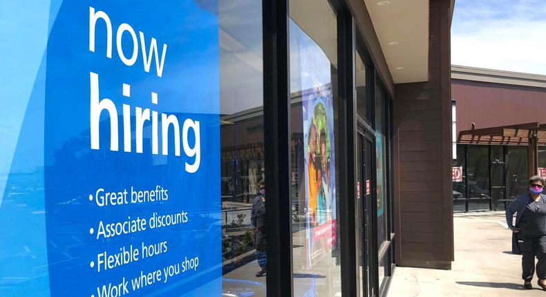 A pedestrian walks by a now hiring sign at Ross Dress For Less store on April 02, 2021 in San Rafael, California.
