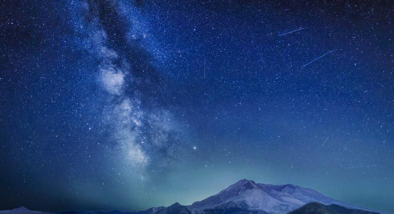 The Delta Aquariids meteor shower and Milky Way over Mount St. Helens, at Windy Ridge in Washington State with Mt. Hood, Oregon visible in the lower left corner. In 2023, it's occurring at the same time as the Alpha Capricornids shower.Diana Robinson Photography/Getty Images