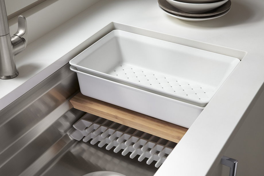 Kohler's Prolific Sink integrates a bamboo cutting board, colander, grated racks, and wash bin inside a standard stainless steel tub. The sink also features a cone-shaped drain for more efficient cleanup.