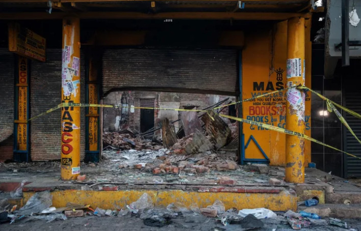 The scene of a looted shop where a charred body was found in Johannesburg on September 4, 2019 [Michele Spatari/AFP/Getty Images]
