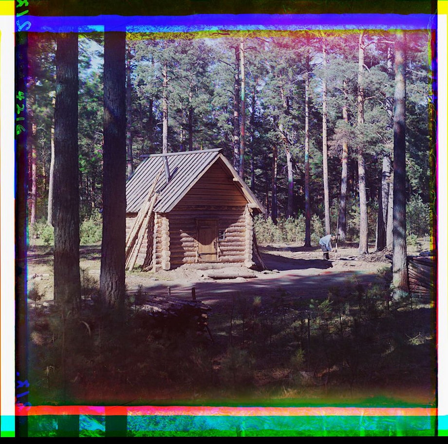 A guardhouse stands in the forest as the guardsman tills the land outside.