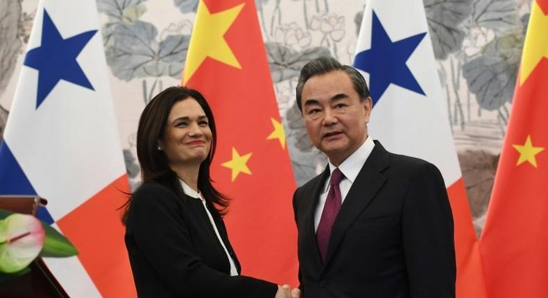 Panama's Vice President and Foreign Minister Isabel Saint Malo shakes hands with Chinese Foreign Minister Wang Yi after the two signed a joint communique agreeing to establish diplomatic relations, in Beijing, on June 13, 2017