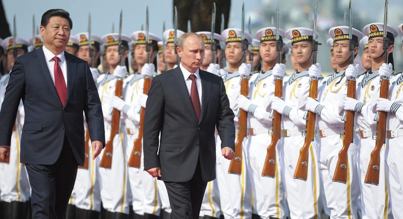 China's President Xi Jinping (L) and his Russian counterpart Vladimir Putin inspect the honor guard as they attend a ceremony to open the Chinese-Russian joint naval drills in Shanghai May 20, 2014. Reuters/Alexei Druzhinin/RIA Novosti/Kremlin