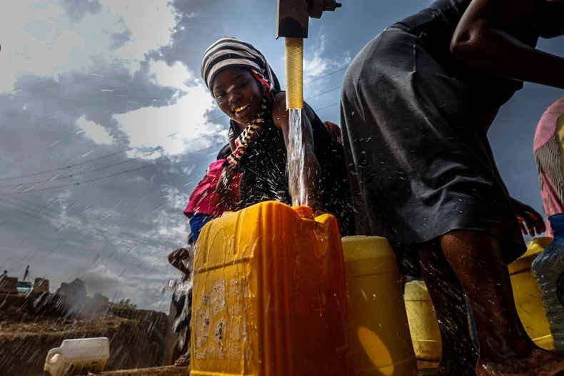 NAIROBI, KENYA - 2022/01/11: A woman is seen filling her water container with water during the water shortage in Nairobi. (Photo by Donwilson Odhiambo/SOPA Images/LightRocket via Getty Images)