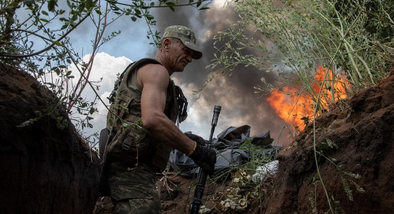 A Ukrainian paratrooper takes shelter in a trench from a BM-21 Grad multiple rocket launcher attack on July 5,2022 in Seversk, Ukraine.Laurent van der Stockt/Getty Images