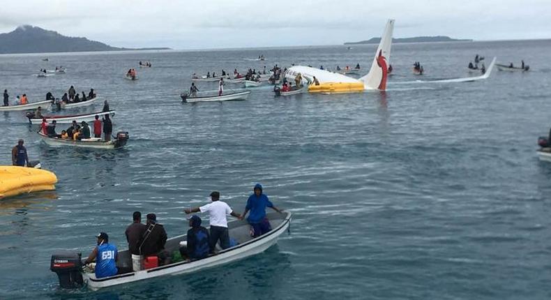 Local boats going out to rescue passengers and crew from an Air Niugini plane that crash-landed off Chuuk, Micronesia.