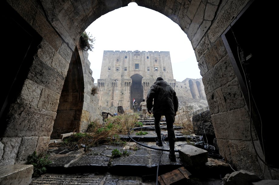 Forces loyal to Syria's President Bashar al-Assad walk inside Aleppo's historic citadel, during a media tour, Syria December 13, 2016.