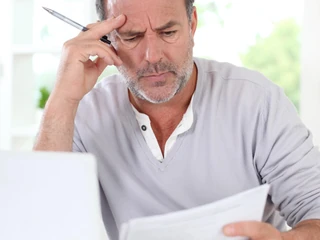 Senior man being puzzled with tax documents