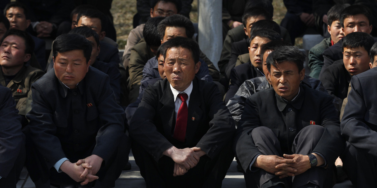 A group of North Korean visitors listen to a guide at Mangyongdae, the birthplace of North Korea founder Kim Il-sung, in Pyongyang, April 9, 2012.