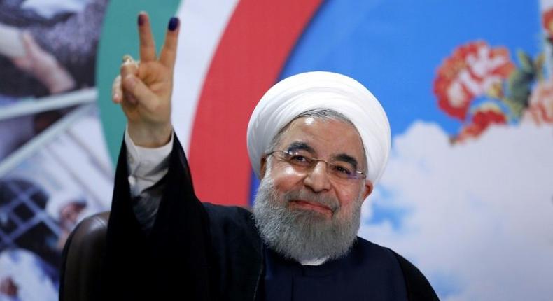 Iranian President Hassan Rouhani gestures to the camera after registering to run for re-election at the interior ministry in Tehran on April 14, 2017