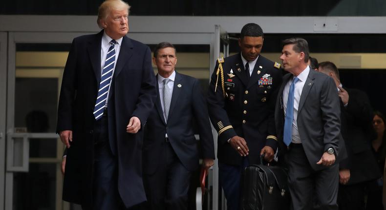 U.S. President Donald Trump leaves the Central Intelligence Agency (CIA) headquarters accompanied by now-former National Security Adviser General Michael Flynn (2nd L) after delivering remarks during a visit in Langley, Virginia U.S., January 21, 2017.