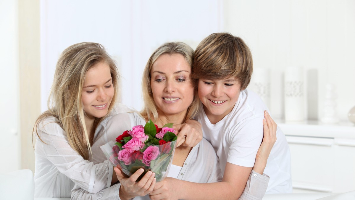 Children offering bunch of flowers on mother's 