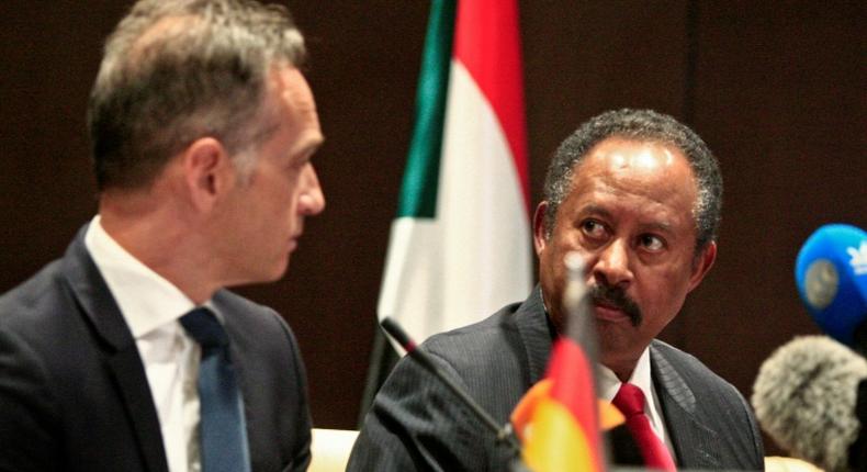 German Foreign Minister Heiko Maas (L) and Sudan's Prime Minister Abdallah Hamdok give a joint press conference in the Sudanese capital Khartoum on Tuesday