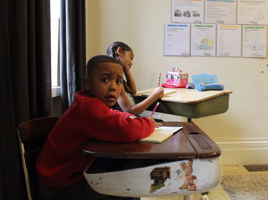 The two oldest Epting children study at their desks in the second-floor room.