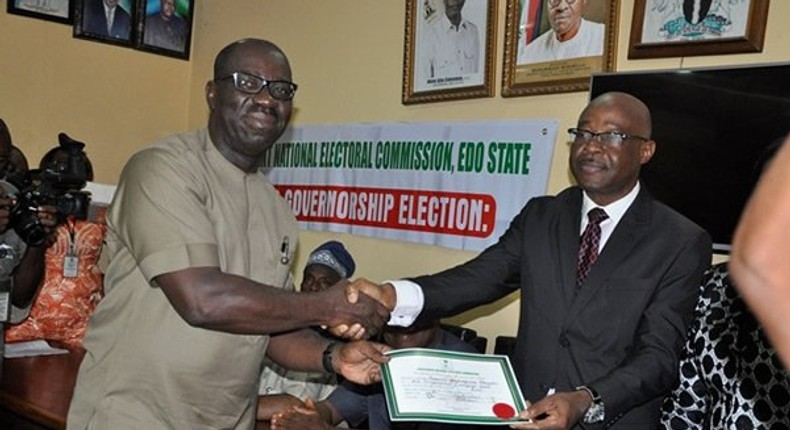 Godwin Obaseki receiving his certificate of return at the INEC office