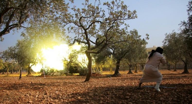 Rebel fighters from the Jaish al-Fatah (or Army of Conquest) brigades fire mortar shells towards western government-controlled districts at the entrance to Aleppo, in the southwestern frontline neighbourhood of Dahiyet al-Assad on October 30, 2016