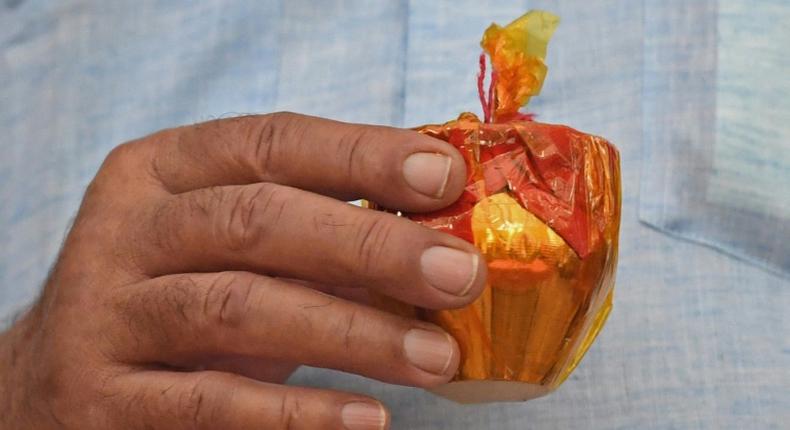 A supporter of Vishva Hindu Parishad holds a pot filled with sacred soil and water from various Hindu holy spots for use constructing the new temple