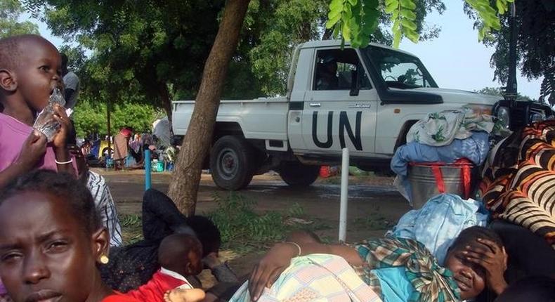 A U.N. truck drives past displaced South Sudanese families resting in a camp for internally displaced people in the United Nations Mission in South Sudan (UNMISS) compound in Tomping, Juba, South Sudan, July 11, 2016. 