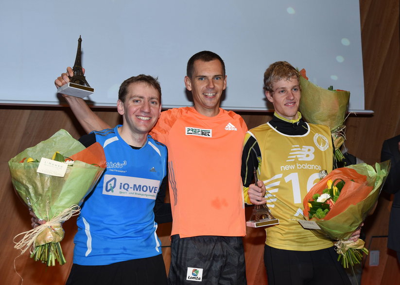 Piotr Łobodziński (w środku) po swym 4. zwycięstwie w biegu na wieżę Eiffla