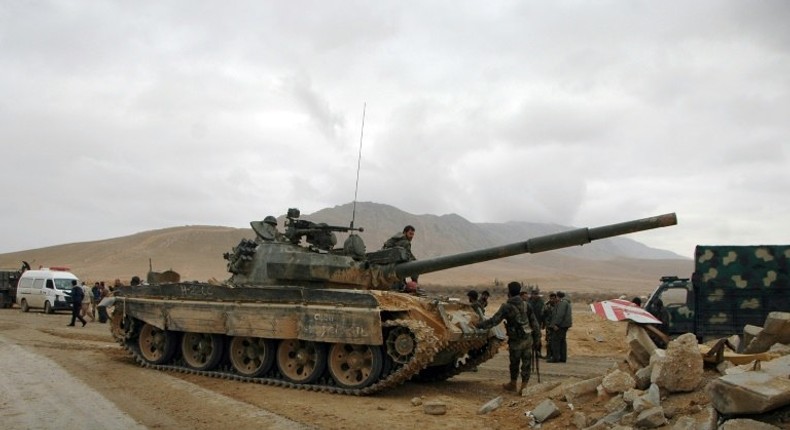 Syrian regime fighters take position as they advance to retake the ancient city of Palmyra, from Islamic State (IS) group fighters on March 2, 2017