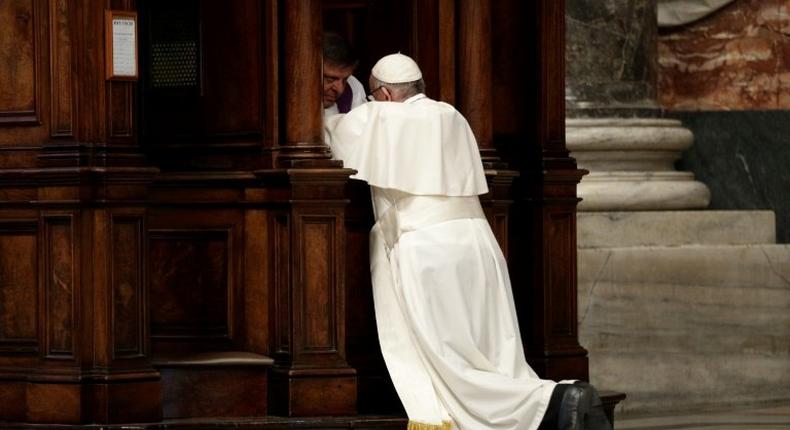 Pope Francis kneels before a priest to confess during the Liturgy of Penance on March 17, 2017 in St. Peter's Basilica at the Vatican