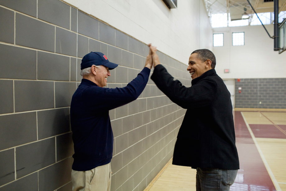 Obama and Biden high-five after watching Sasha Obama and Maisy Biden, the Vice President's granddaughter, play in a basketball game in Chevy Chase, Maryland, February 27, 2010.