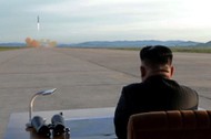 FILE PHOTO: North Korean leader Kim Jong Un watches the launch of a Hwasong-12 missile in this undat