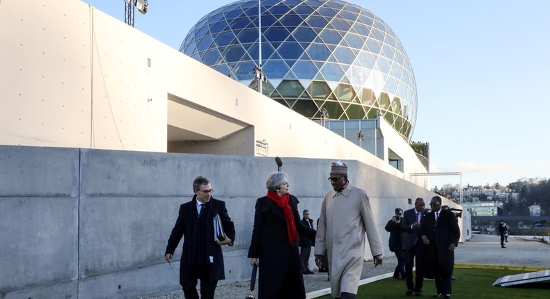 Britain's Prime Minister Theresa May (C) and Nigerian President Muhammadu Buhari (R) arrive to attend the One Planet Summit at La Seine Musicale venue in Boulogne-Billancourt, near Paris, France December 12, 2017. REUTERS/Ludovic Marin/Pool