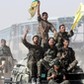 Syrian Democratic Forces (SDF) fighters ride atop of military vehicles as they celebrate victory in Raqqa