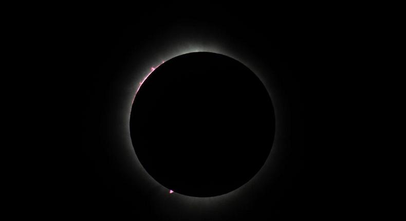 The eclipse also revealed the sun's prominences, which appeared as pink curls on its outer edges.