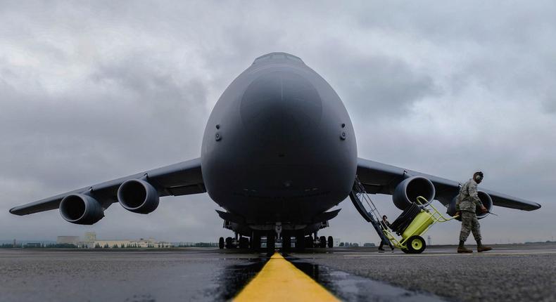An Airman clears the runway for a C-5 Galaxy at Yokota Air Base, Japan, August 31, 2015.