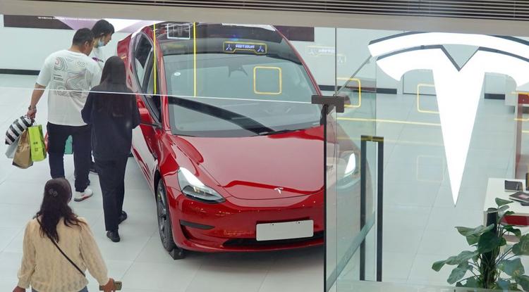 Kínai vásárlók nézegetik a Tesla Model Y-t