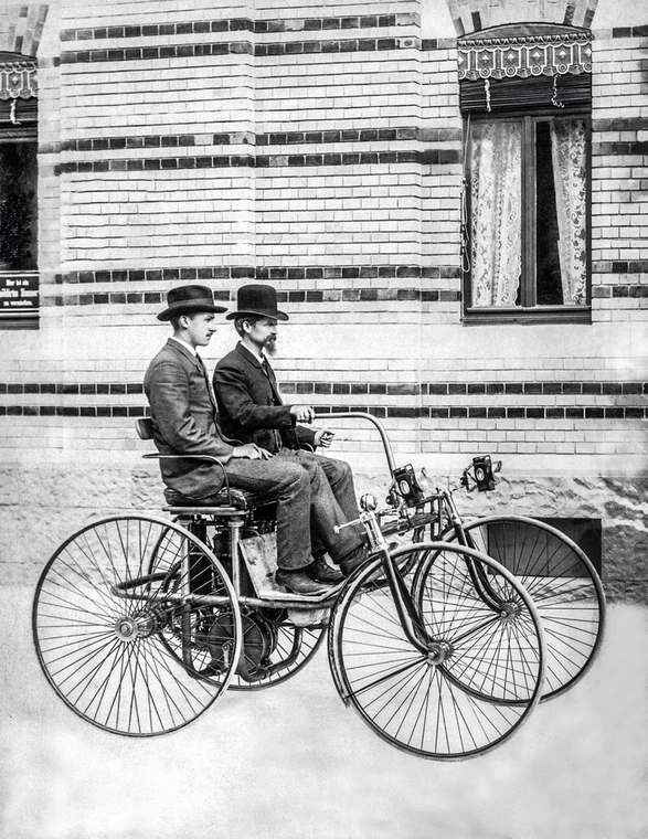 Stahlradwagen z 1889 roku z Maybachem za kierownicą. Obok niego siedzi syn Daimlera Adolf.