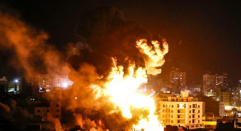 Fire and smoke billow above buildings in Gaza City during reported Israeli strikes on March 25, 2019