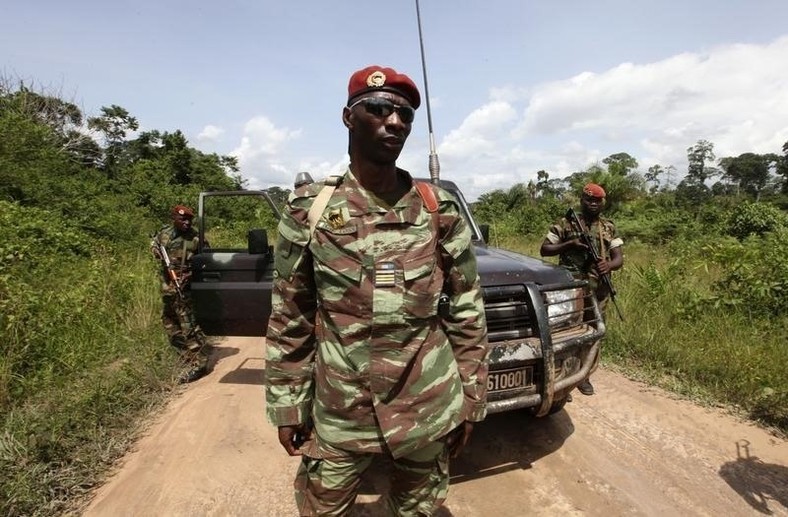 Losseni Fofana of the Ivory Coast Republican forces (FRCI) and commander of the military operation in the Tai area, stands with his men during a patrol on the road to Para village, in the western Tai area near Ivory Coast's border with Liberia, June 17, 2012. REUTERS/Luc Gnago
