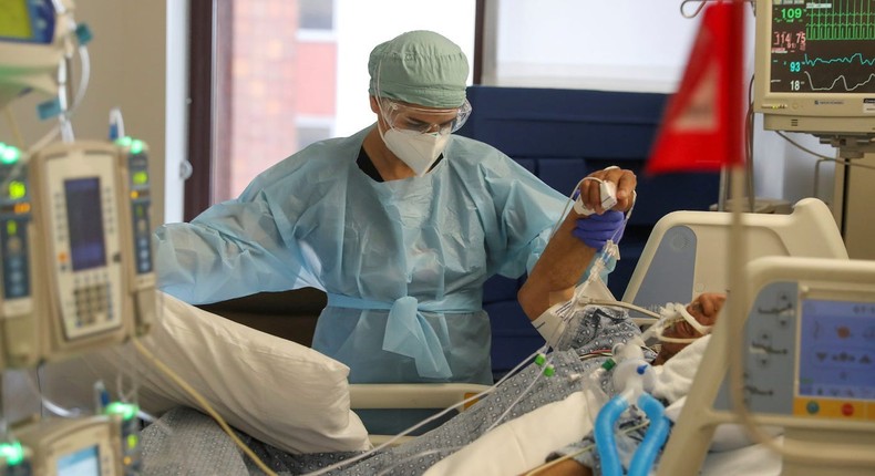 Co-director of the intensive care unit at CommonSpirit's Dignity Health-California Hospital Medical Center, Dr. Zafia Anklesaria, attends to a COVID-19 patient in the hospital where she works in Los Angeles, California on May 18, 2020.