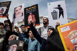 Iranians shout slogans during a protest against President Donald Trump's decision to walk out of a 2