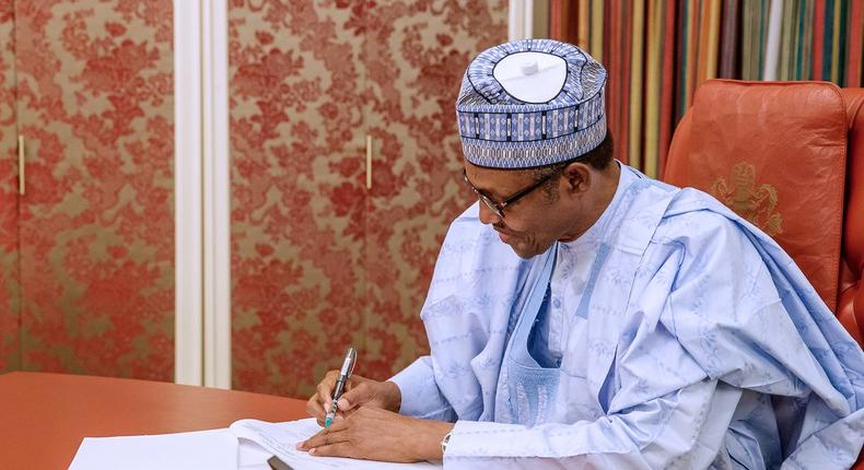 President Muhammadu Buhari signs the new minimum wage bill into law on Thursday, April 18, 2019. [Presidency]