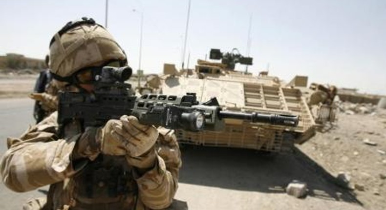 A British soldier looks through the scope of his rifle after a roadside bomb attack that targeted their convoy in Basra, 420 km (260 miles) northeast of Baghdad,in this file photo from September 12, 2008.